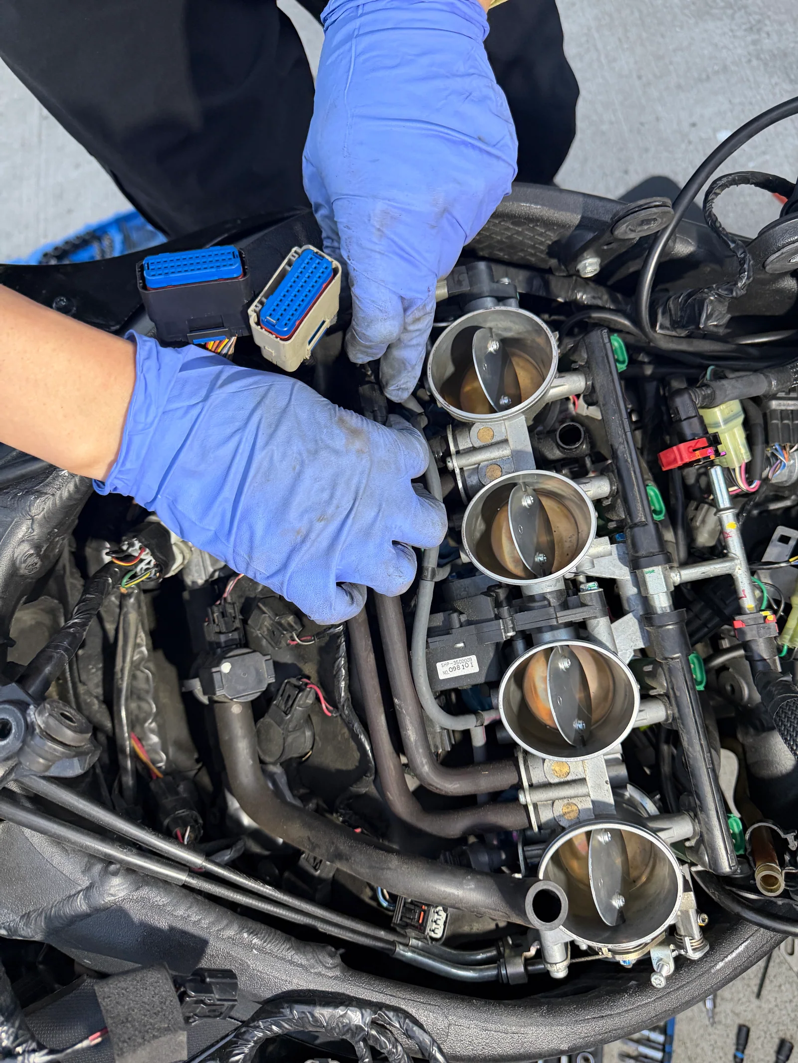 Four throttle bores and electrical connectors exposed on a 2011 Kawasaki Ninja ZX-10R