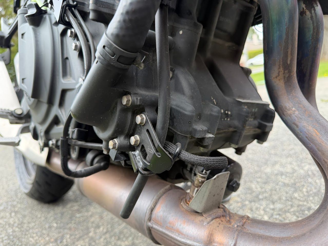 Motorcycle engine detail inspected during an on-site repair visit