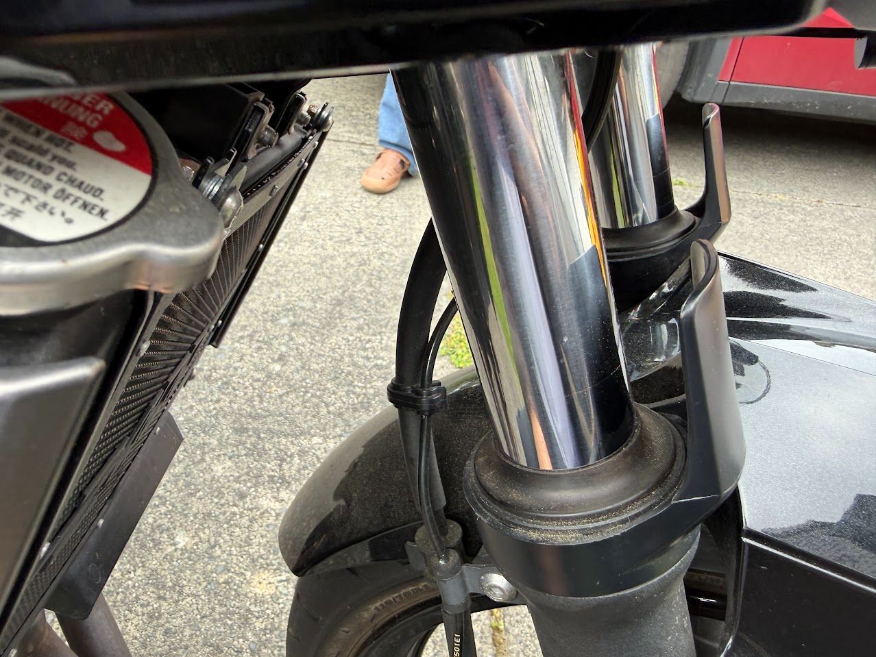 Motorcycle front end and fork area being checked during mobile service