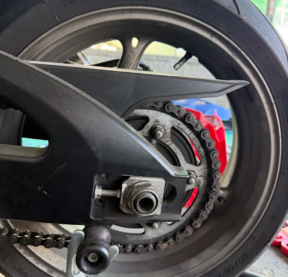 Motorcycle front suspension and radiator area checked after wet-weather riding